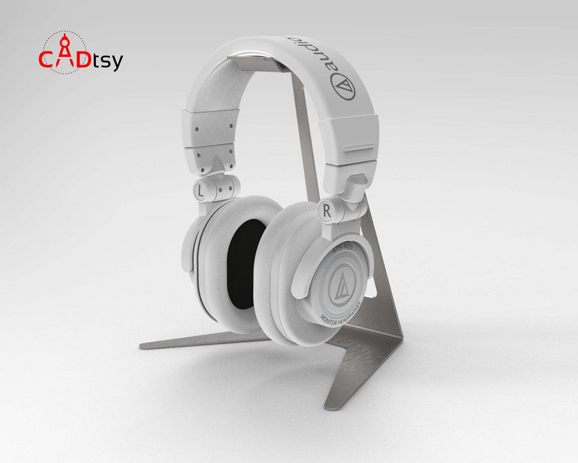 White headphones displayed on gray metal stand, close front view
