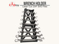 A black metal wrench holder, made from a DXF file, mounted on a wall and holding a set of combination wrenches.